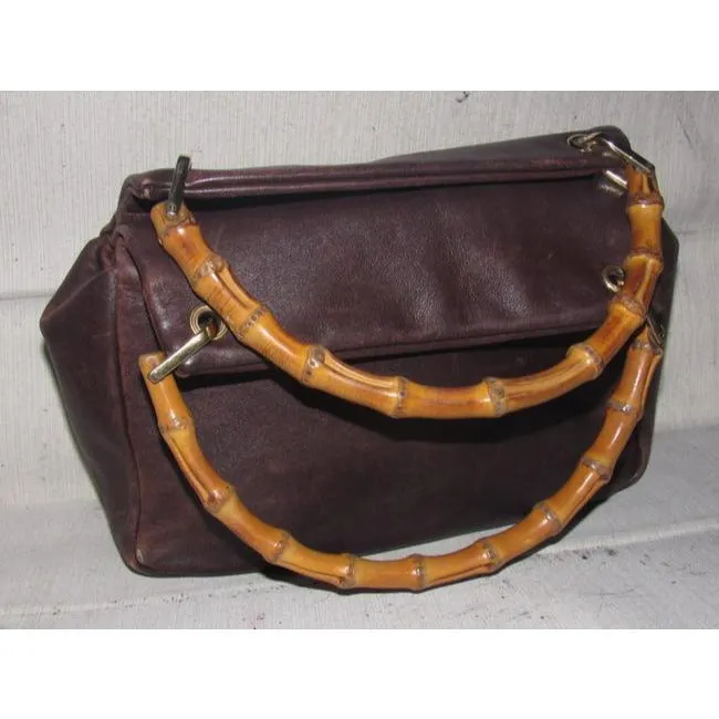 Gucci, mod look, supple brown leather satchel style bag with two bamboo handles & accents, gold tone hardware, a center zip closure