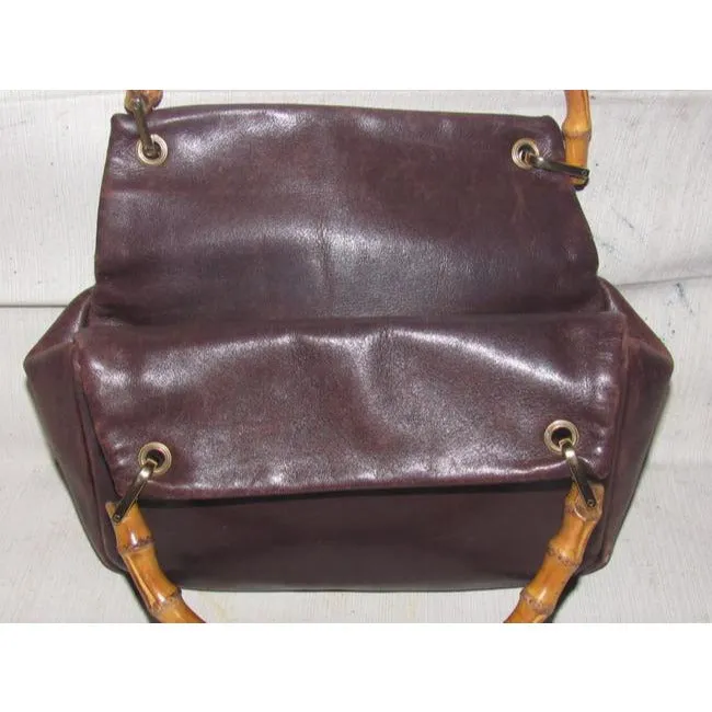 Gucci, mod look, supple brown leather satchel style bag with two bamboo handles & accents, gold tone hardware, a center zip closure