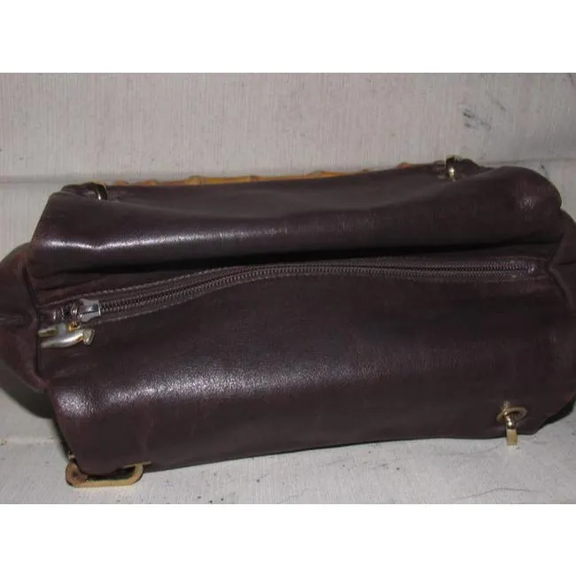 Gucci, mod look, supple brown leather satchel style bag with two bamboo handles & accents, gold tone hardware, a center zip closure
