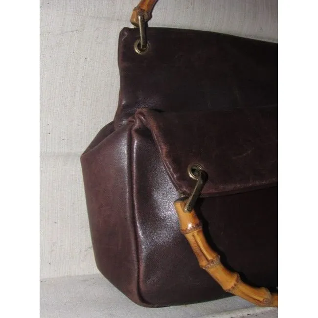 Gucci, mod look, supple brown leather satchel style bag with two bamboo handles & accents, gold tone hardware, a center zip closure