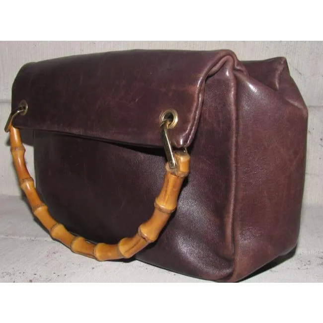 Gucci, mod look, supple brown leather satchel style bag with two bamboo handles & accents, gold tone hardware, a center zip closure