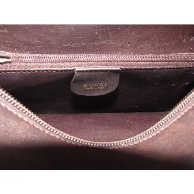 Gucci, mod look, supple brown leather satchel style bag with two bamboo handles & accents, gold tone hardware, a center zip closure