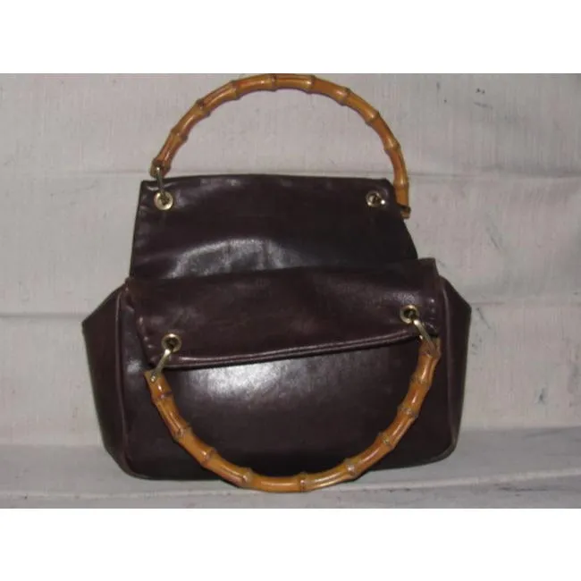 Gucci, mod look, supple brown leather satchel style bag with two bamboo handles & accents, gold tone hardware, a center zip closure