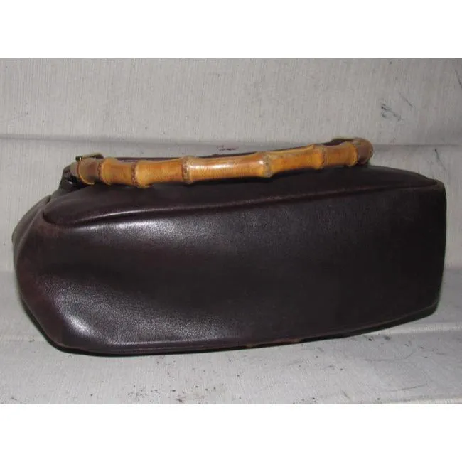 Gucci, mod look, supple brown leather satchel style bag with two bamboo handles & accents, gold tone hardware, a center zip closure